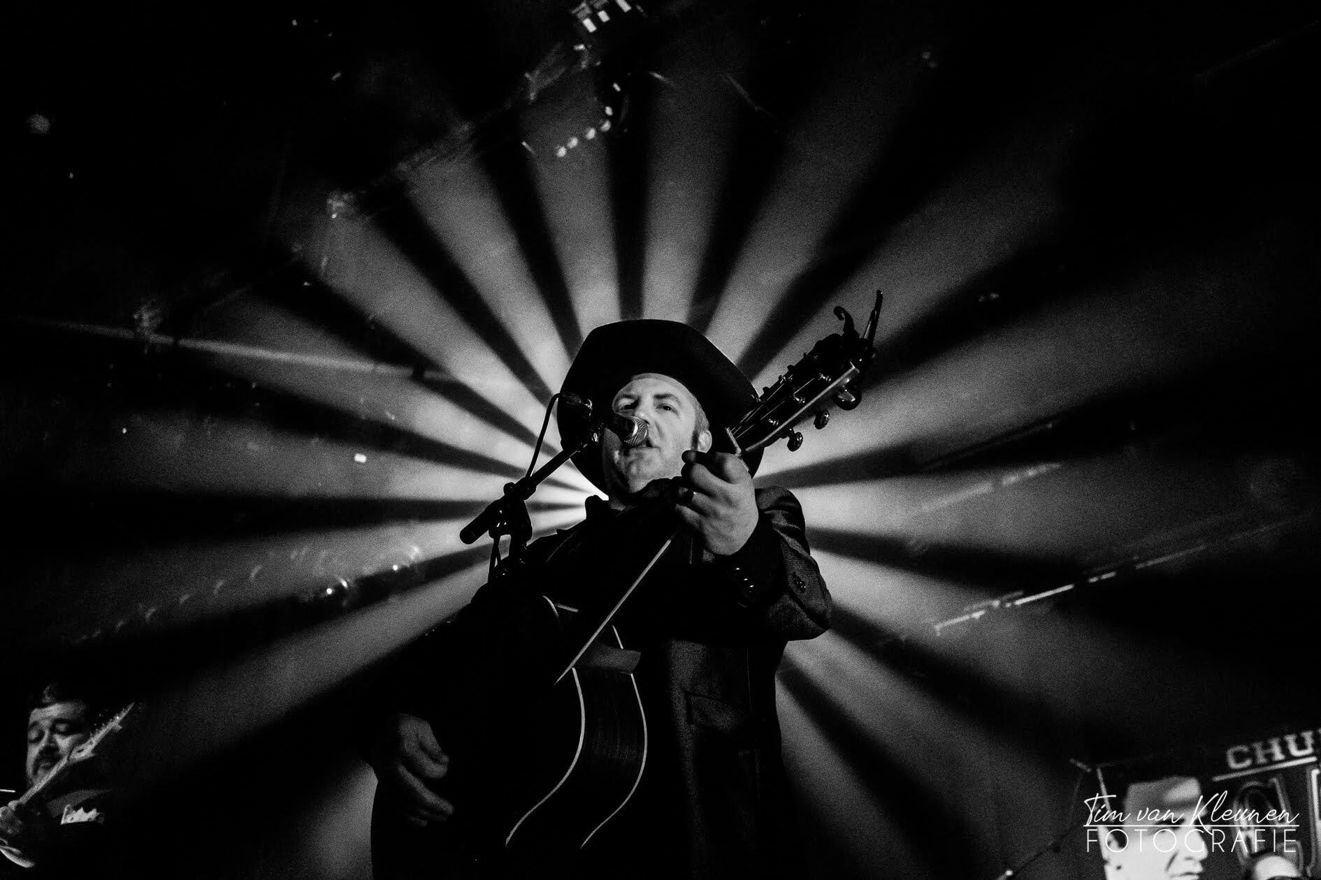 Church of Cash performer with dramatic lighting